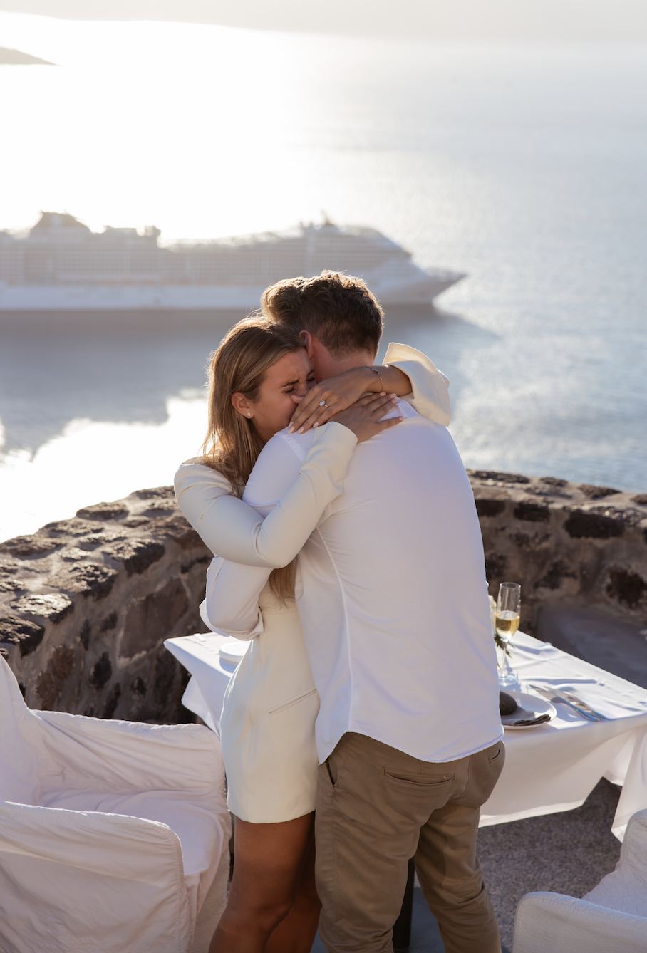 Nick and Matilda embracing just after the proposal, overlooking the caldera